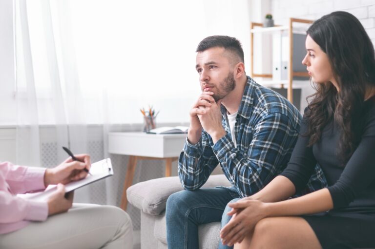 a serious young couple with a counselor