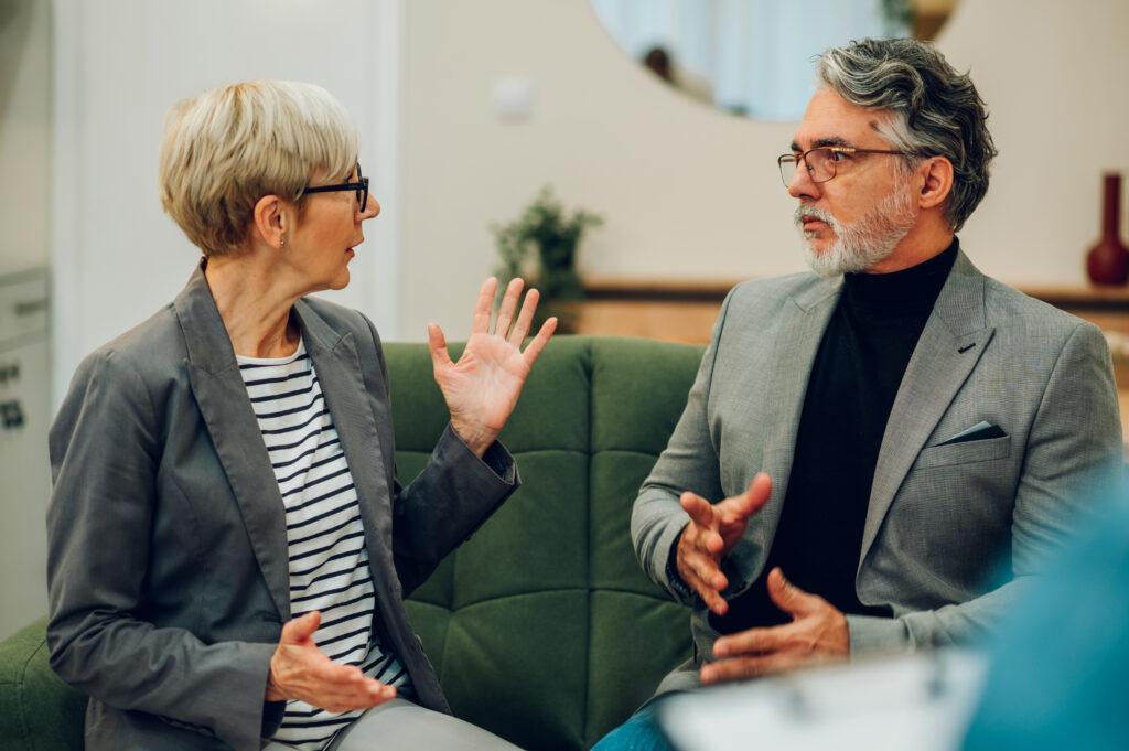 Retired couple on a therapy session at marriage and couple's office having relationship problem. Elderly married people trying to resolve conflict with help of professional counselor