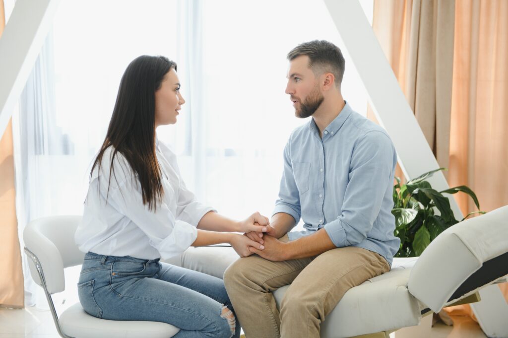 A young couple talking about whether or not they should do premarital counseling