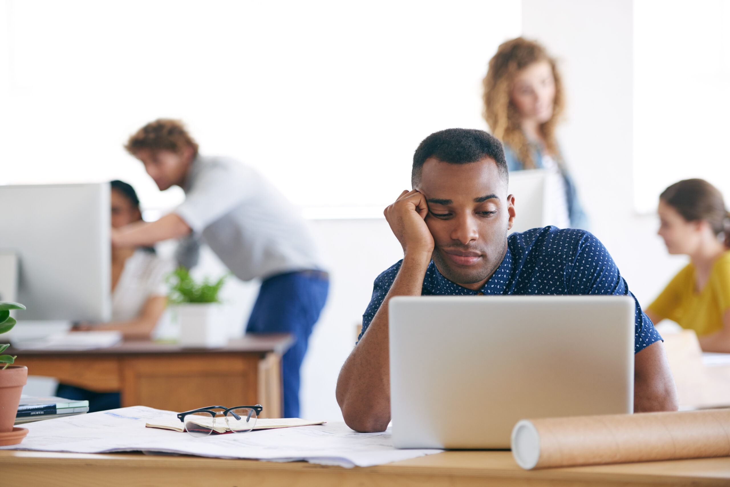 Business man experiencing burnout from being a workaholic and not having a good work-life balance