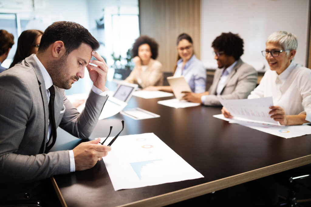 Business People Meeting in a Conference Room to discuss how to manage team conflict