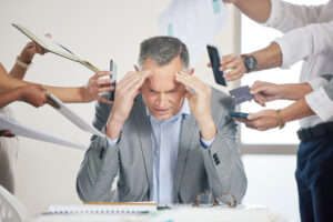 A business executive sitting in a board room dealing with leadership stress