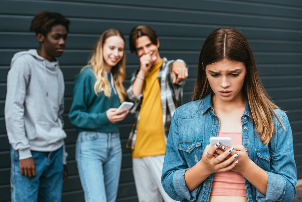A photo of a teen girl who is being the victim of cyberbullying by her peers