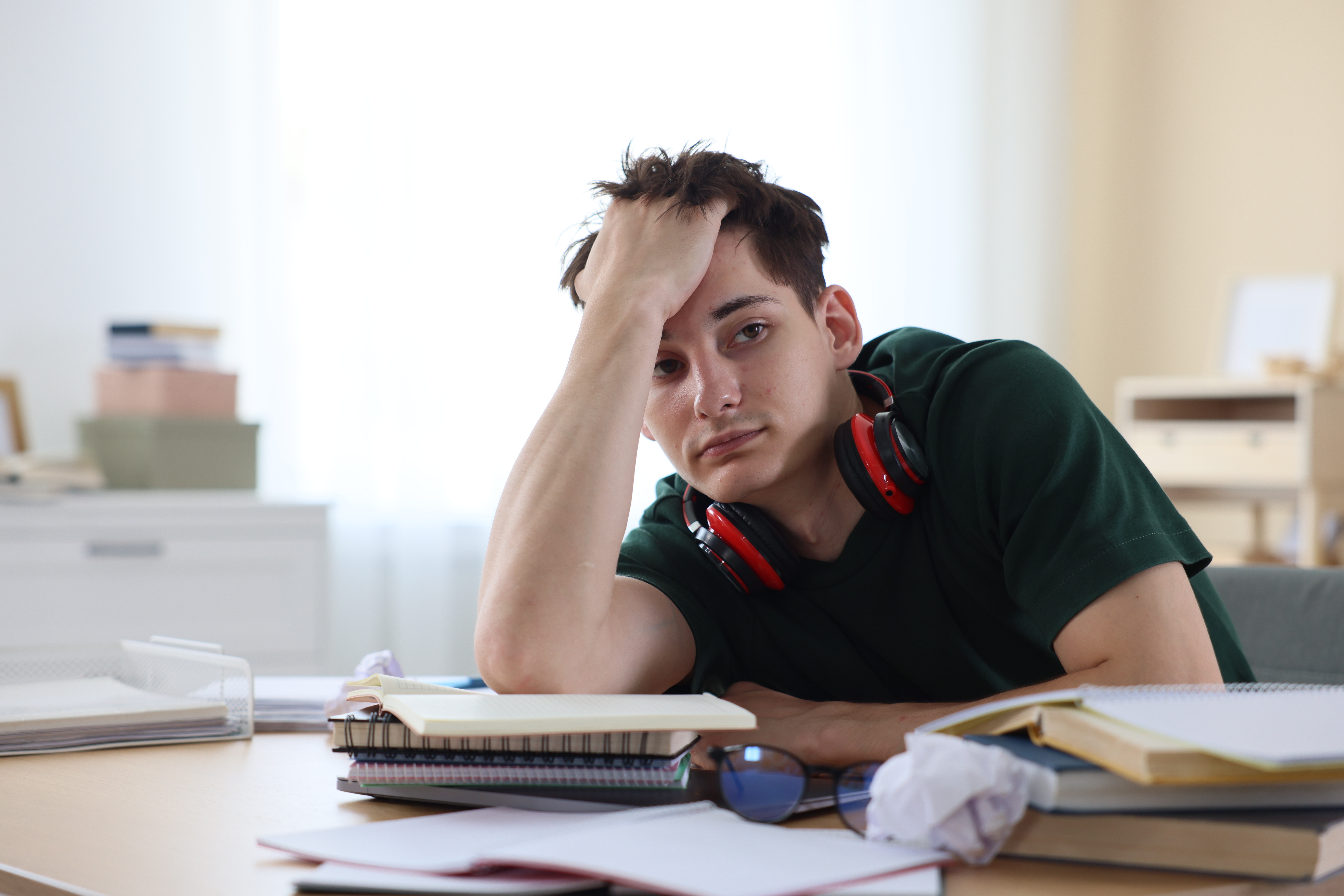 A photo of a freshman student struggling with his freshman year of college & dealing with failing grades