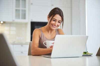 woman smiling while on a video call